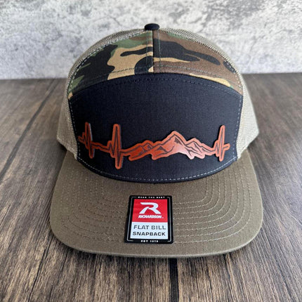 Front view of camo Richardson 112 mountain hat with engraved heartbeat leather patch