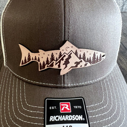 Close-up of leather patch featuring mountain and fish design