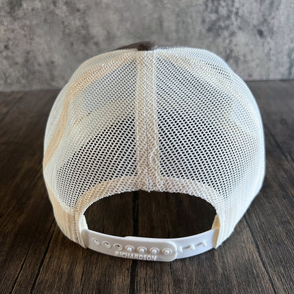 Hat back showcasing mesh back and snapback closure of the mountain fish hat