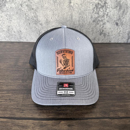 Surviving Fatherhood Hat, Leather Patch Dad Hat, Richardson 112 Trucker Cap, Funny Beer Dad Gift, Father's Day Hat - Patch Palooza