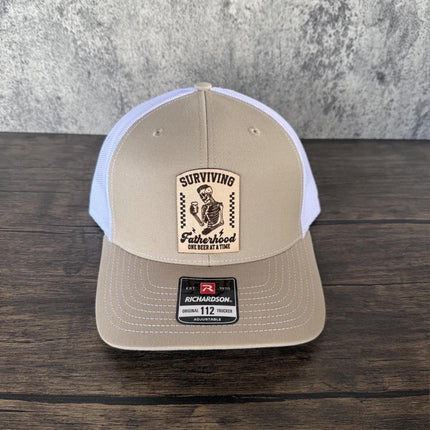 Surviving Fatherhood Hat, Leather Patch Dad Hat, Richardson 112 Trucker Cap, Funny Beer Dad Gift, Father's Day Hat - Patch Palooza