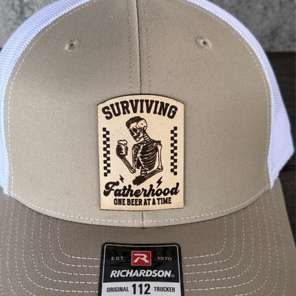 Surviving Fatherhood Hat, Leather Patch Dad Hat, Richardson 112 Trucker Cap, Funny Beer Dad Gift, Father's Day Hat - Patch Palooza