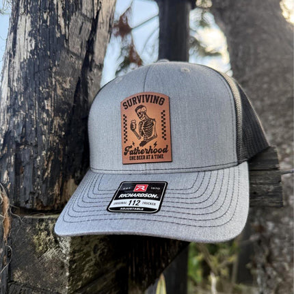 Surviving Fatherhood Hat, Leather Patch Dad Hat, Richardson 112 Trucker Cap, Funny Beer Dad Gift, Father's Day Hat - Patch Palooza